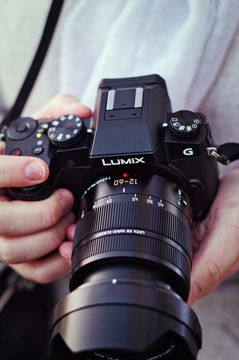 Close-up of hands holding a Panasonic Camera