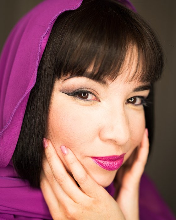 Close up portrait of a woman in a purple headscarf