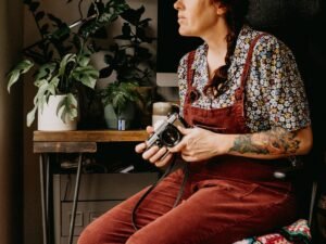 A film photographer sitting with a camera