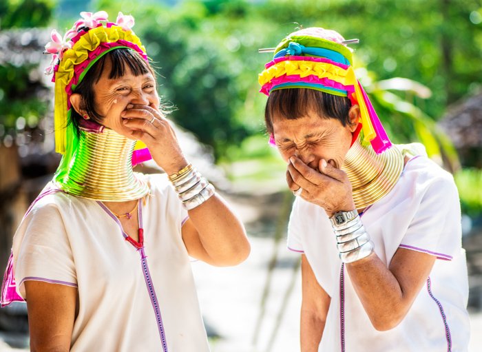 Incident lit portrait of women in traditional costume laughing