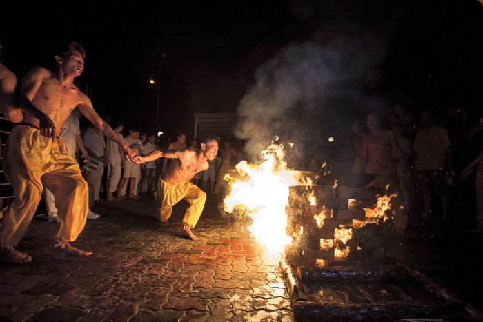 A performance by a bonfire at night shot with a wide aperture