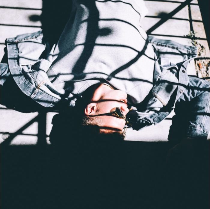 Photo of a model lying on the ground with natural light