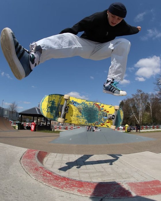 Skateboarding doing a trick shot with a fisheye lens