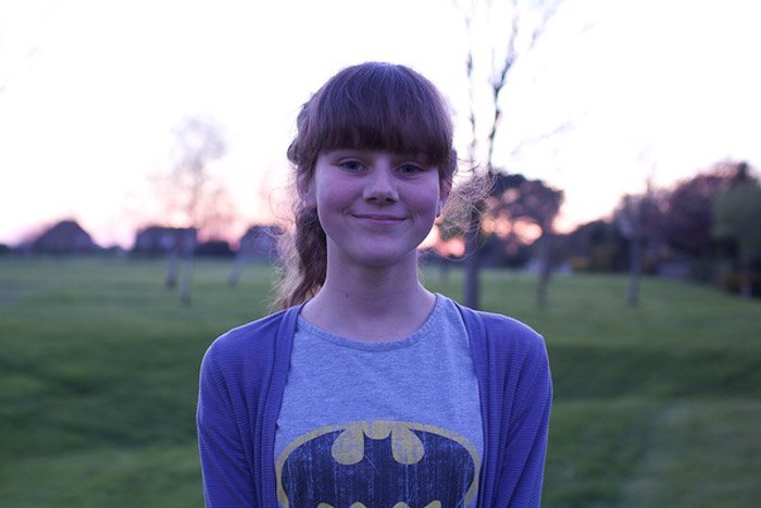 A portrait of a young girl posing outdoors, 